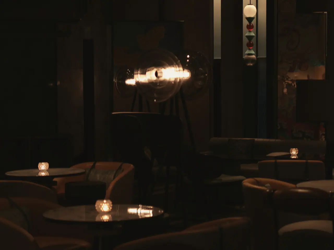 The lounge, deep chairs under low lamps